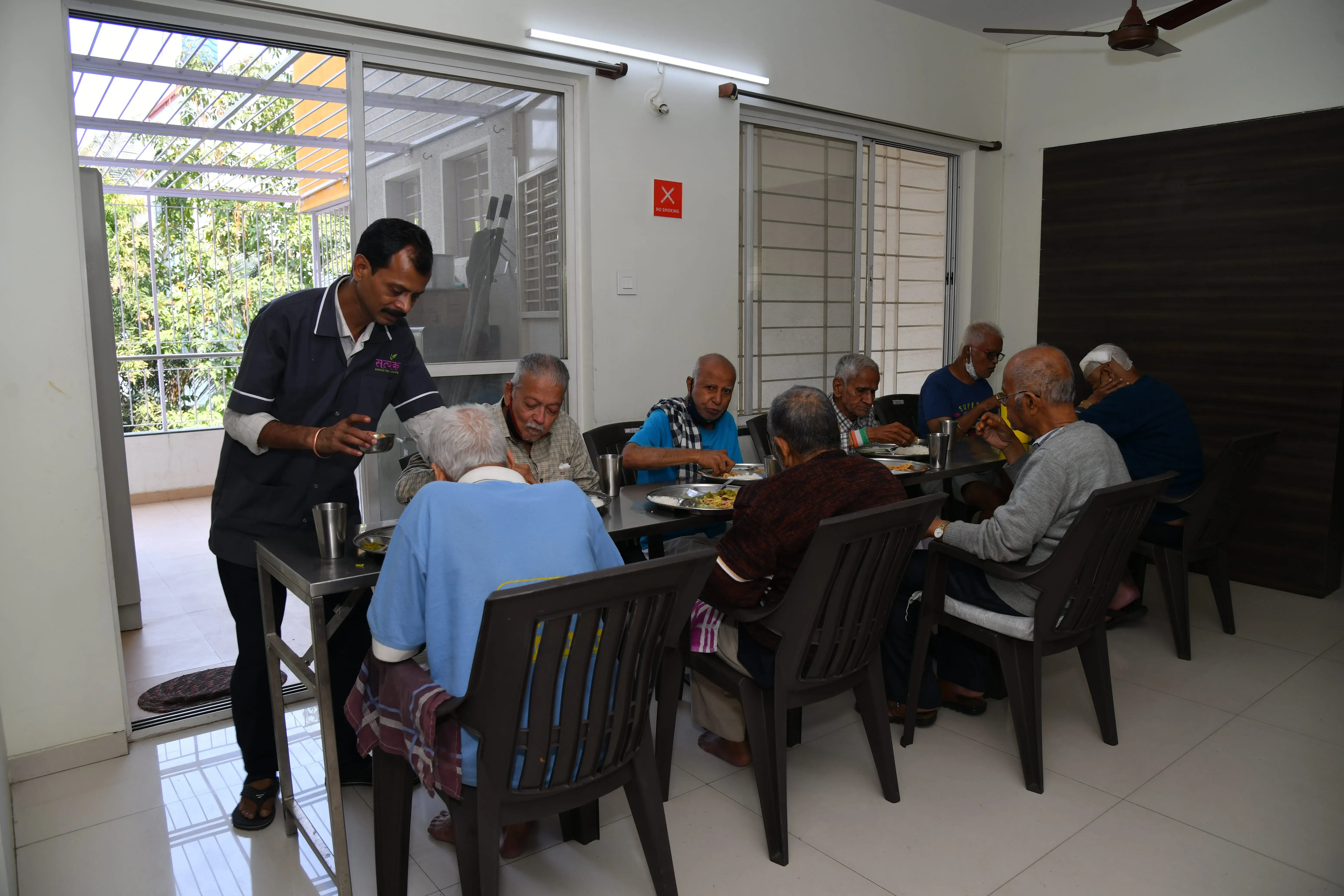 Residents at the dining table with an attendant