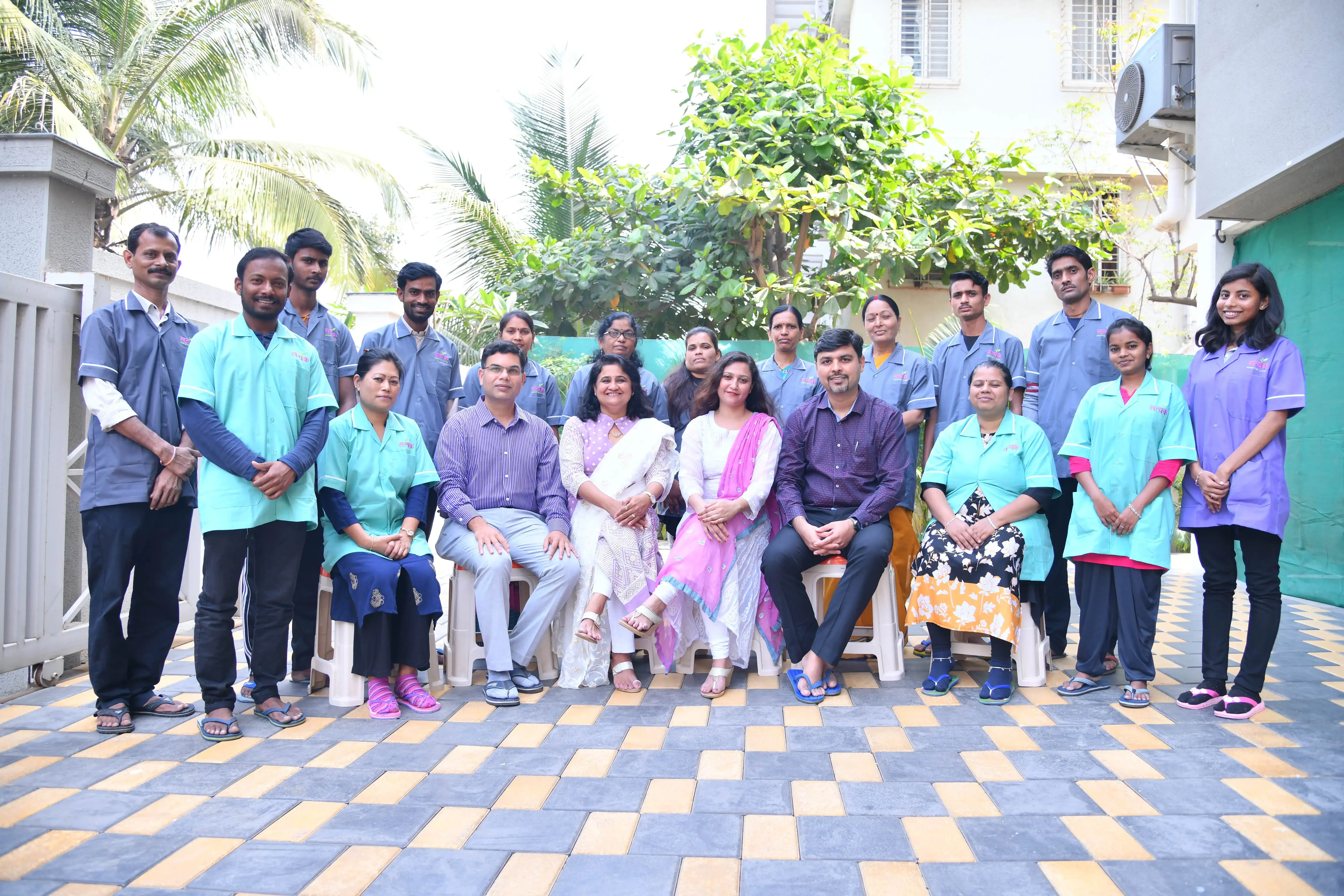Satyak's doctors, nurses and attendants together in the courtyard of the home